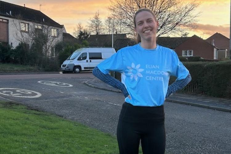 Anna Stuckert in a Euan MacDonald Centre branded running shirt setting off on her morning training run