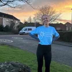 Anna Stuckert in a Euan MacDonald Centre branded running shirt setting off on her morning training run