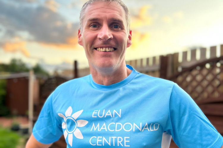 A picture of Gregor Miller in a Euan MacDonald Centre running shirt. Gregor is fundraising for MND research by running 165 miles from Inverness to Edinburgh at the end of September. 