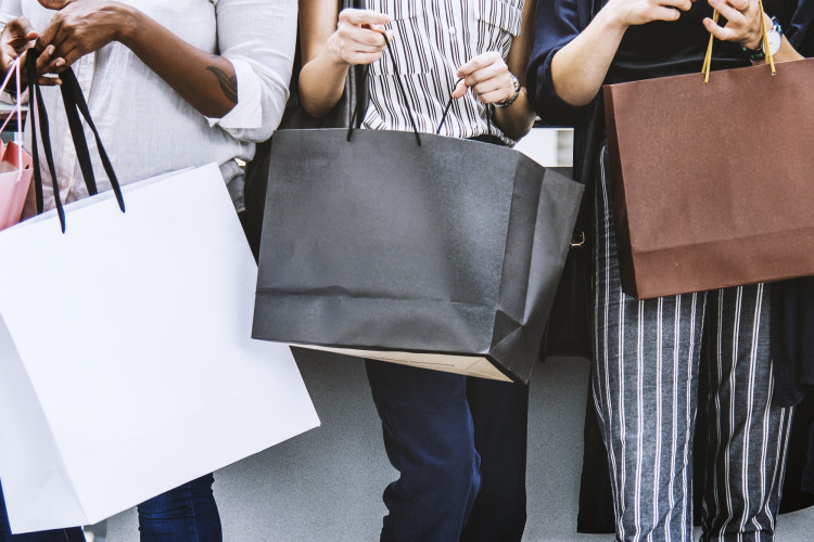 people holding shopping bags