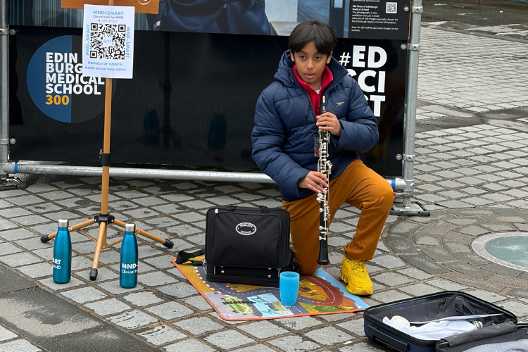 Adi Pal busking with an oboe at the Mound, Edinburgh during the University of Edinburgh Medical School's 300 Faces Exhibition