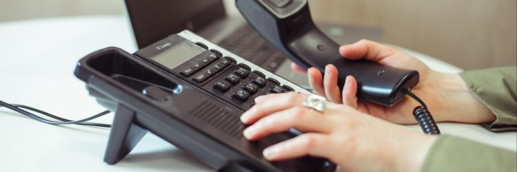 Close up of someone dialing on a landline phone