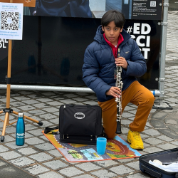 Adi Pal busking with an oboe at the Mound, Edinburgh during the University of Edinburgh Medical School's 300 Faces Exhibition